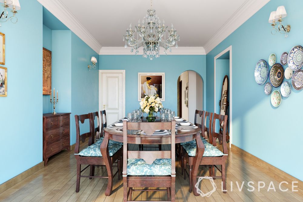 boman irani-dining-powder blue walls-chandelier-wooden furniture