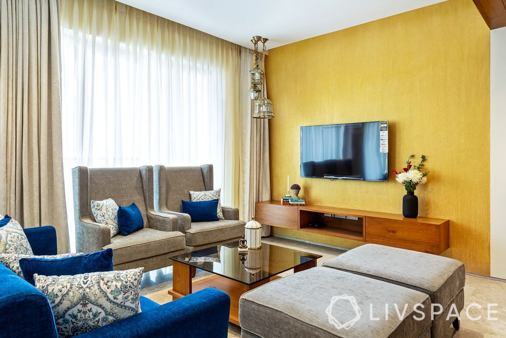 TV-unit-yellow-wall-living-room-sofa-armchair-ottoman