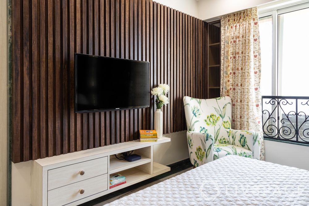 TV-unit-panel-bedroom-wooden-shelves-armchair-curtains