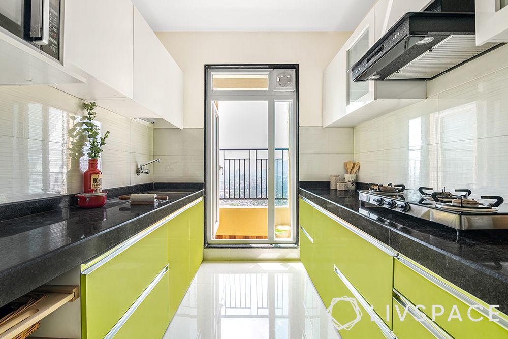 Lime green cabinets-white wall cabinets-tandem drawers-granite countertop-marine ply laminate finish-glass shutters-tandem-granite-semi modular