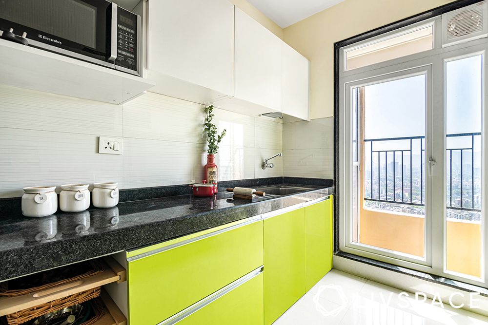 Lime green cabinets-white wall cabinets-tandem drawers-granite countertop-marine ply laminate finish-glass shutters-tandem-granite-semi modular