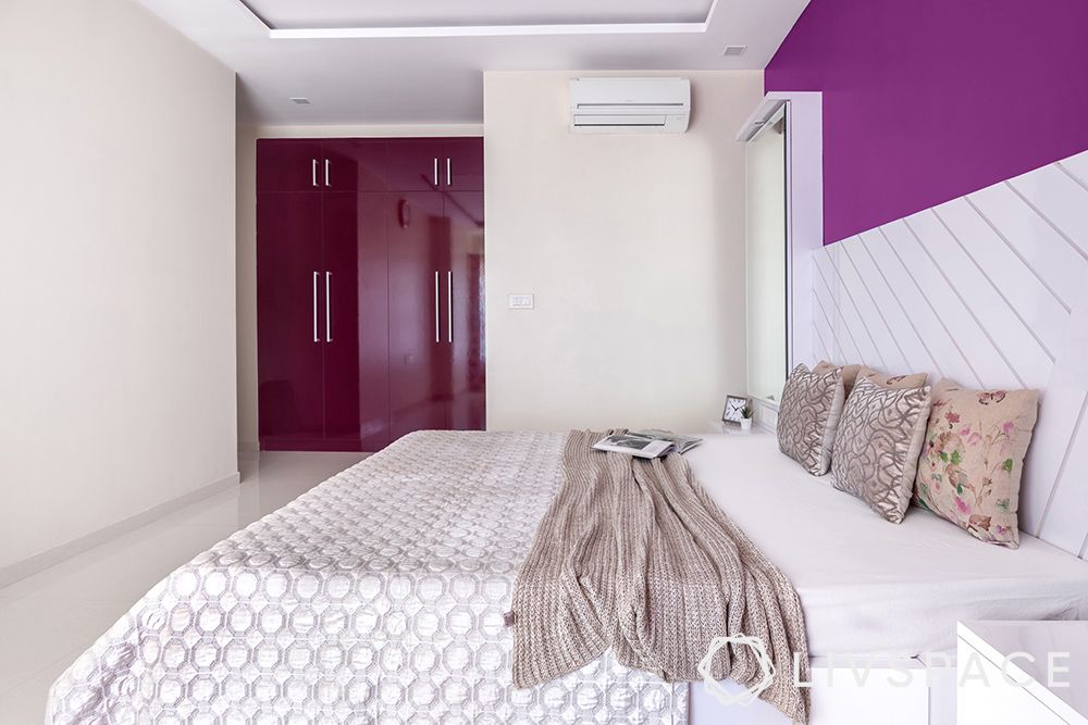 interior designer in thane-master bedroom-purple walls-custom bed-vanity unit-glossy wardrobes