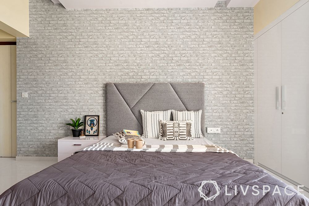 interior designer in thane-grey brick wallpaper-grey headboard-red wardrobe-bed designs