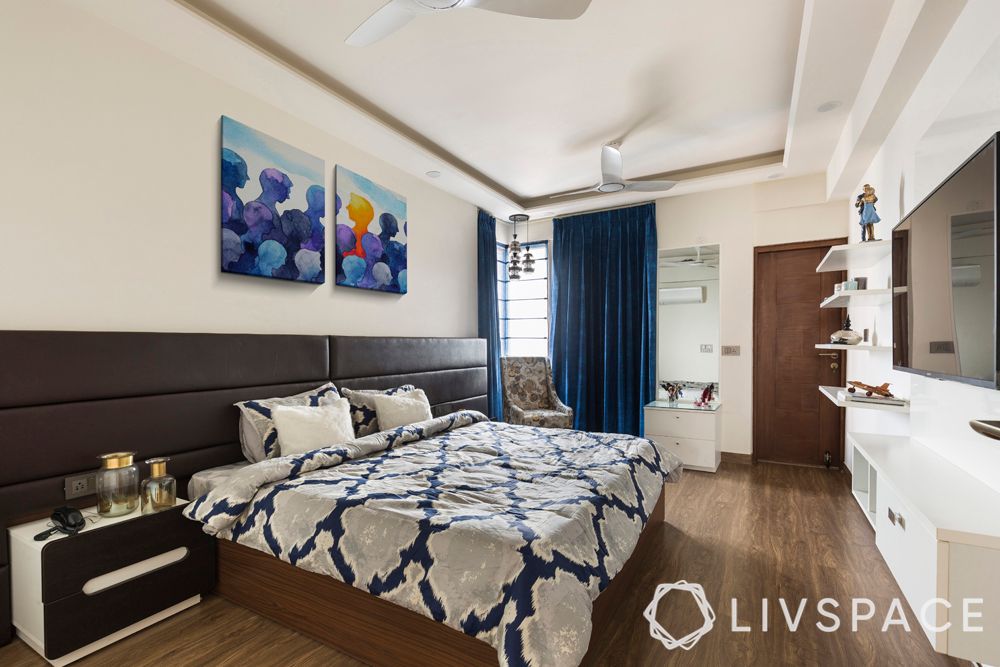 Master-bedroom-leather-headboard-bed-wooden-flooring-curtain
