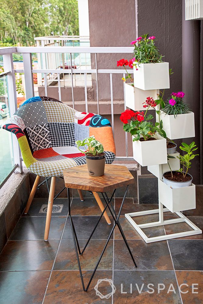 small-balcony-ideas-white-planters-patchwork-chair-flowers