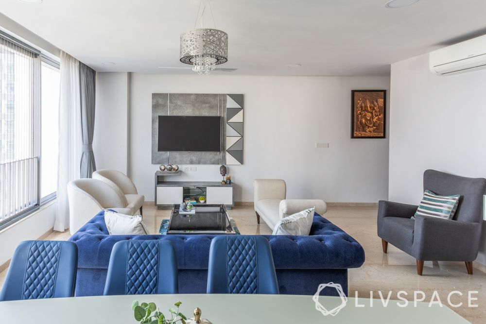 three bhk flat interior- tv unit designs-blue chairs-blue sofa
