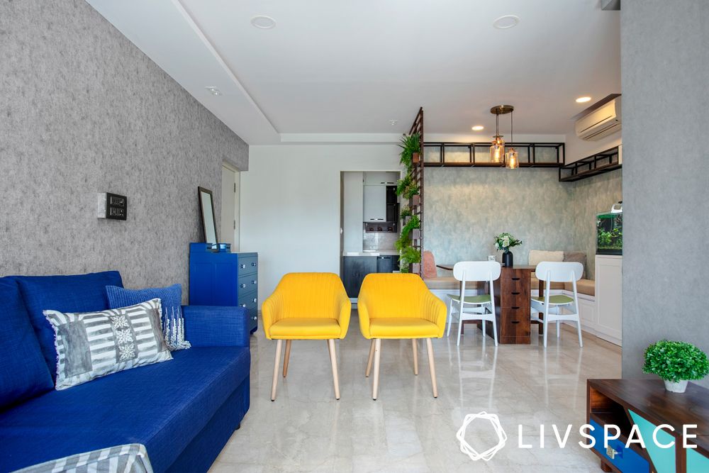 2bhk house design-living room-blue sofa-accent chairs-jaali partition