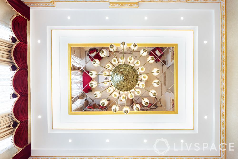 ceiling design-false mirror ceiling-chandelier-red and gold interiors