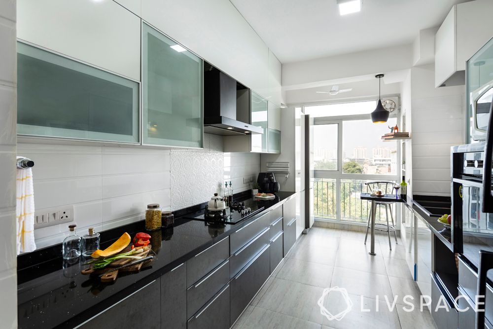 small kitchen design-grey-white-cabinets-breakfast-table-black-counter