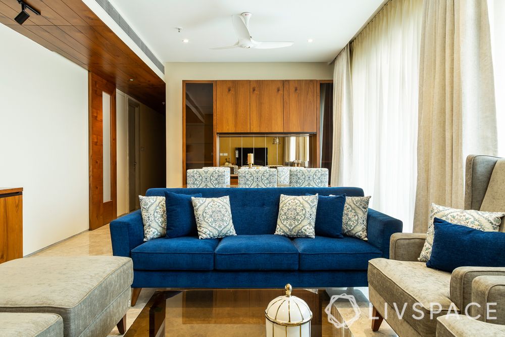 3bhk flat interior designs-blue sofa-veneer panel