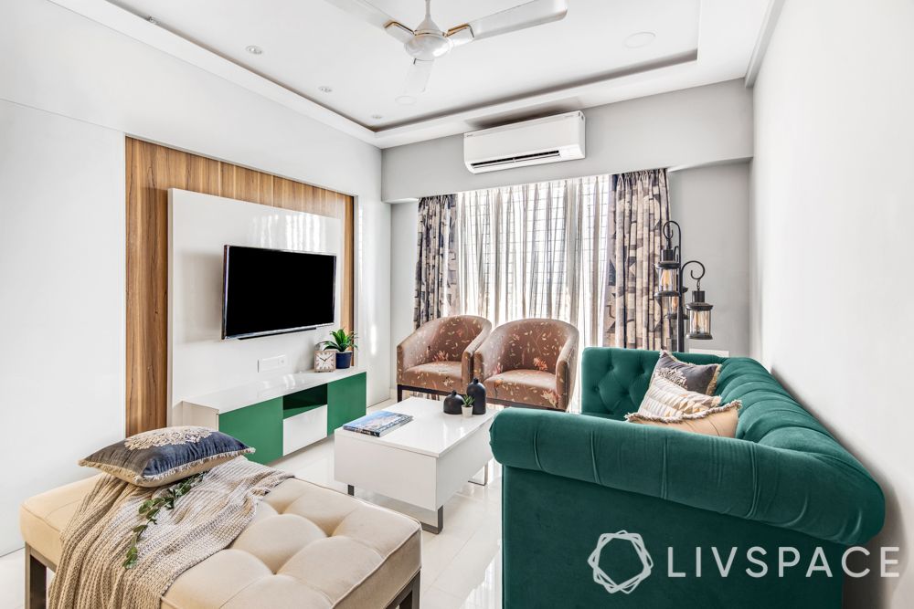 interiors-designers-in-Mumbai-living-room-emerald-sofa-accent-chairs-TV-unit-centre-table