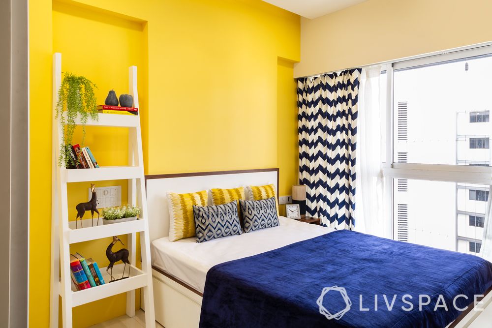 interiors-designers-in-Mumbai-bedroom-yellow-wall-ladder-storage-unit-bed