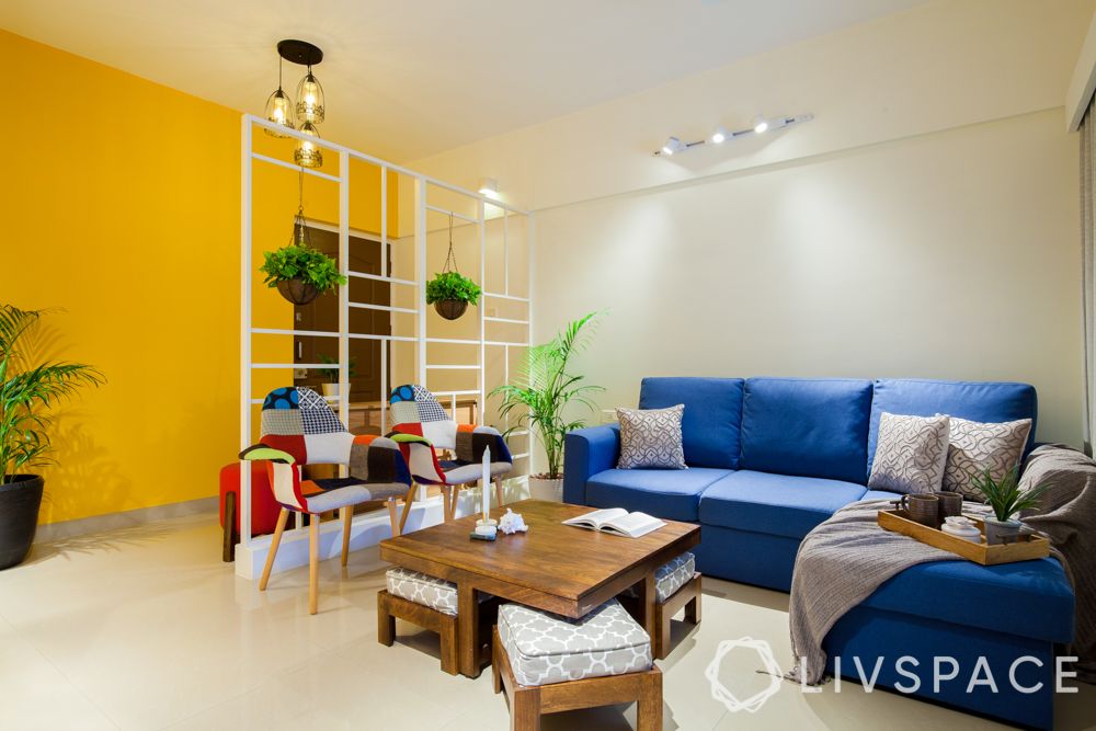 yellow wall-blue sofa