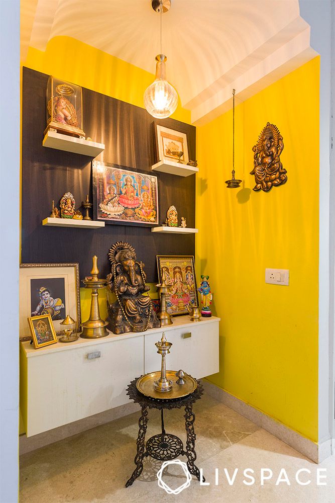 yellow-pooja-room-with-white-floating-cabinet