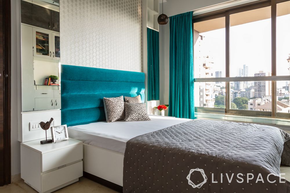 mumbai house-master bedroom-teal headboard-hydraulic bed-dresser and storage unit