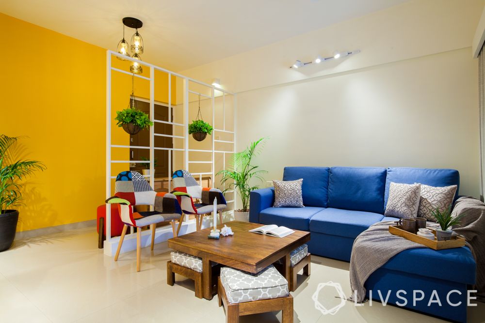 living-room-ideas-multi-functional-furniture-coffee-dining-table-yellow-wall-blue-couch