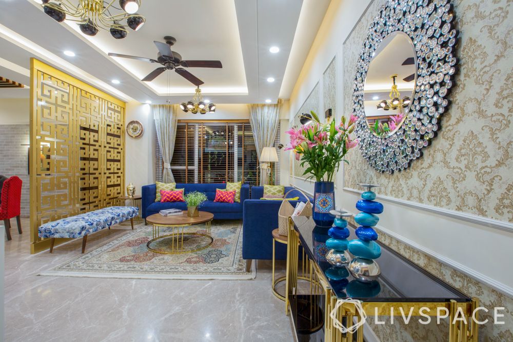 maximalism-living-room-noida-accent-mirror-gold-partition-blue-couch
