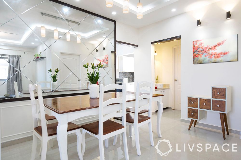 small modern house design-Bengaluru home-mirrored wall-dining table-white interiors