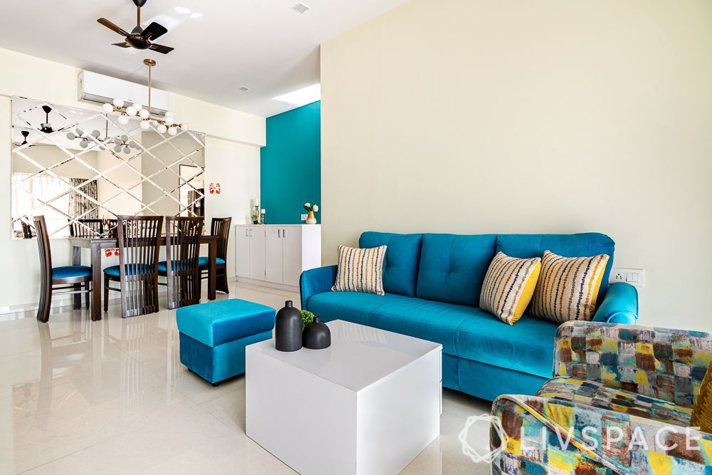 3-bhk-interior-design-cost-living-room-blue-sofa-mirrored-wall