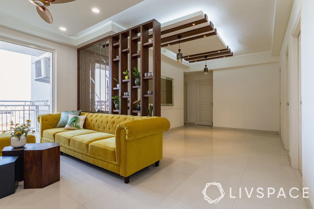 home-interiors-in-Delhi-living-room-wooden-partition-modular-rafters-yellow-sofa