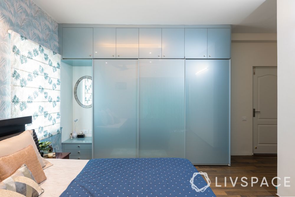 3bhk-flat-in-bangalore-master-bedroom-blue-acrylic-wardrobe