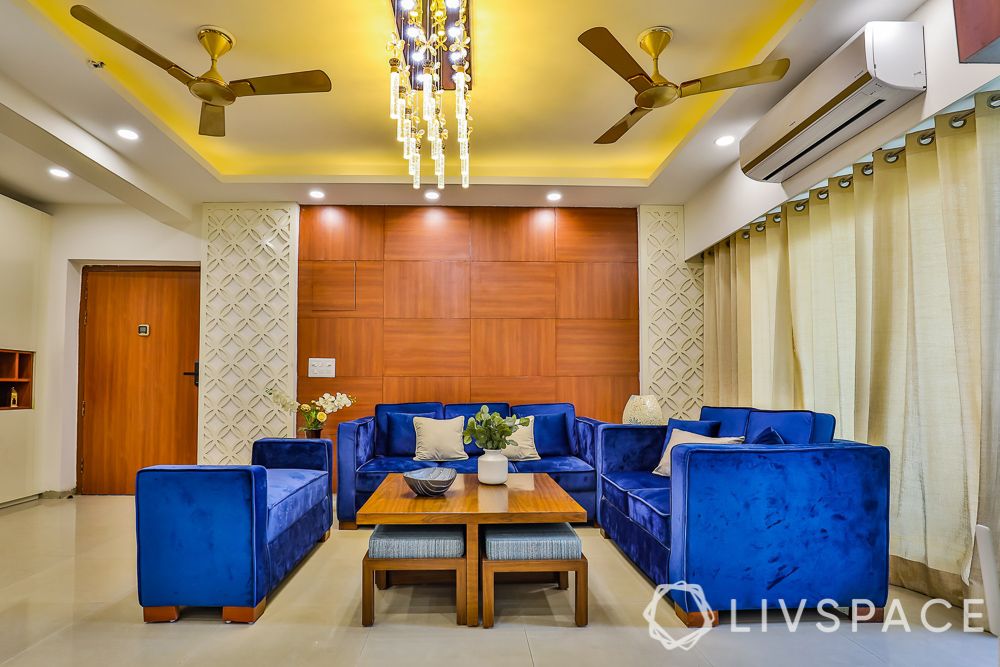3BHK-Noida-blue-sofa-wooden-paneling