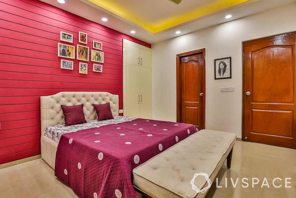 3BHK-Noida-red-bedroom-back-paneling-footstool
