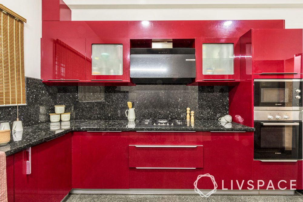 https://jumanji.livspace-cdn.com/magazine/wp-content/uploads/sites/2/2022/06/22132251/red-glossy-l-shaped-kitchen.jpg