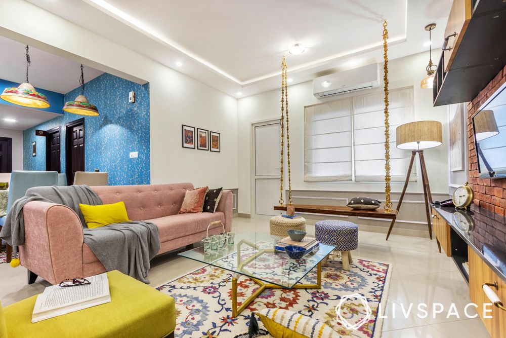 sobha-aspire-living-room-swing-glass-centre-table-pink-sofa-3-bhk-room-design
