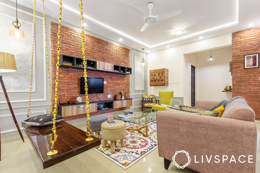 sobha-aspire-living-room-wooden-pooja-unit-ottomans-3-bhk-room-design