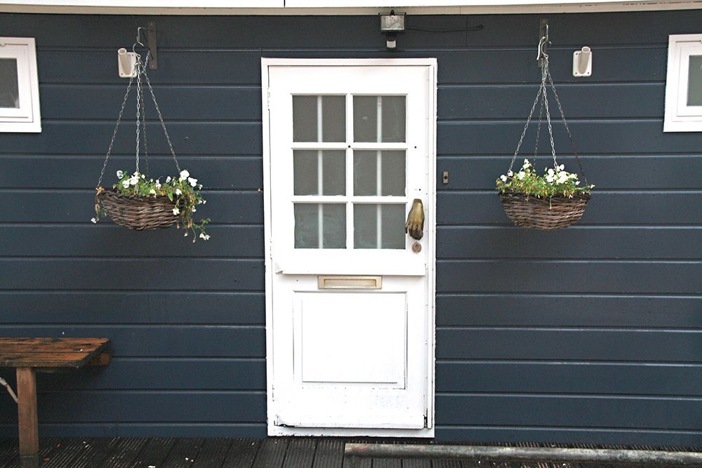 white-dutch-main-door-entrance-design-for-flats-with-hanging-planters