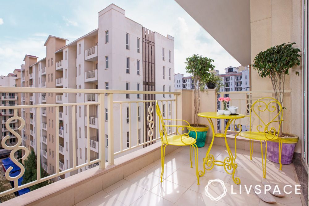 minimal-balcony-design-with-yellow-chairs-and-table