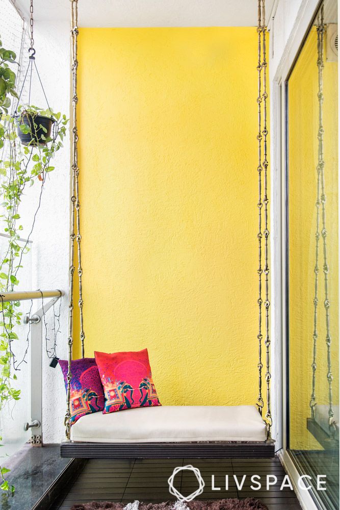 small-balcony-design-outside-with-swing-and-yellow-wall