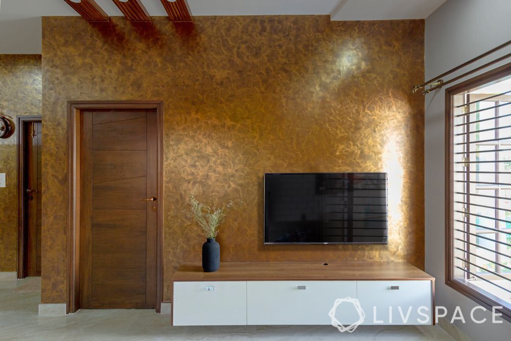 modular-tv-unit-design-against-gold-accent-wall