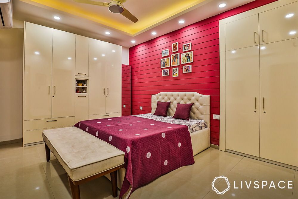 bedroom-with-magenta-accent-wall-and-beige-bed-headboard