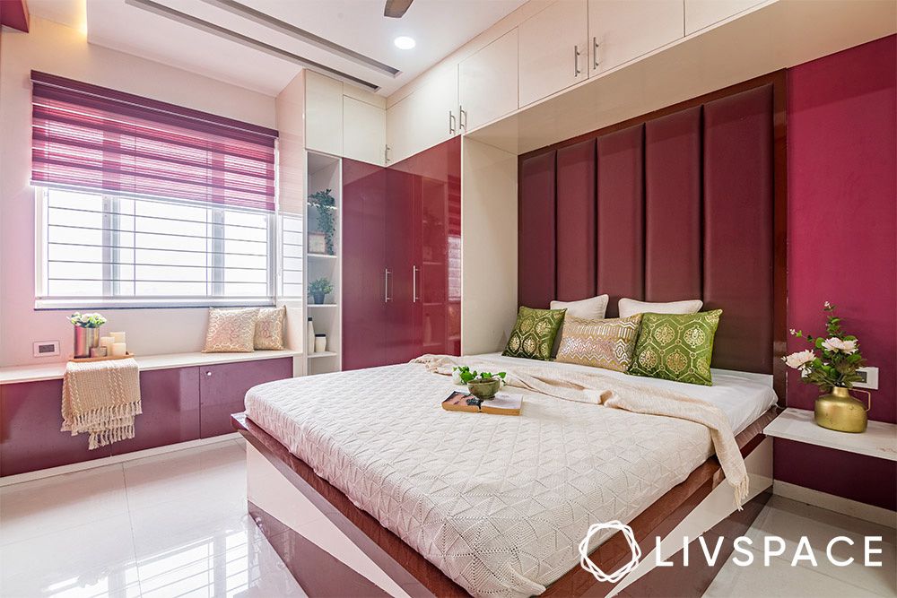 bedroom-with-magenta-headboard-wall-wardrobe-and-bay-window-storage