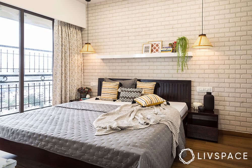 bedroom-with-brick-like-wall-hanging-lights-and-plants