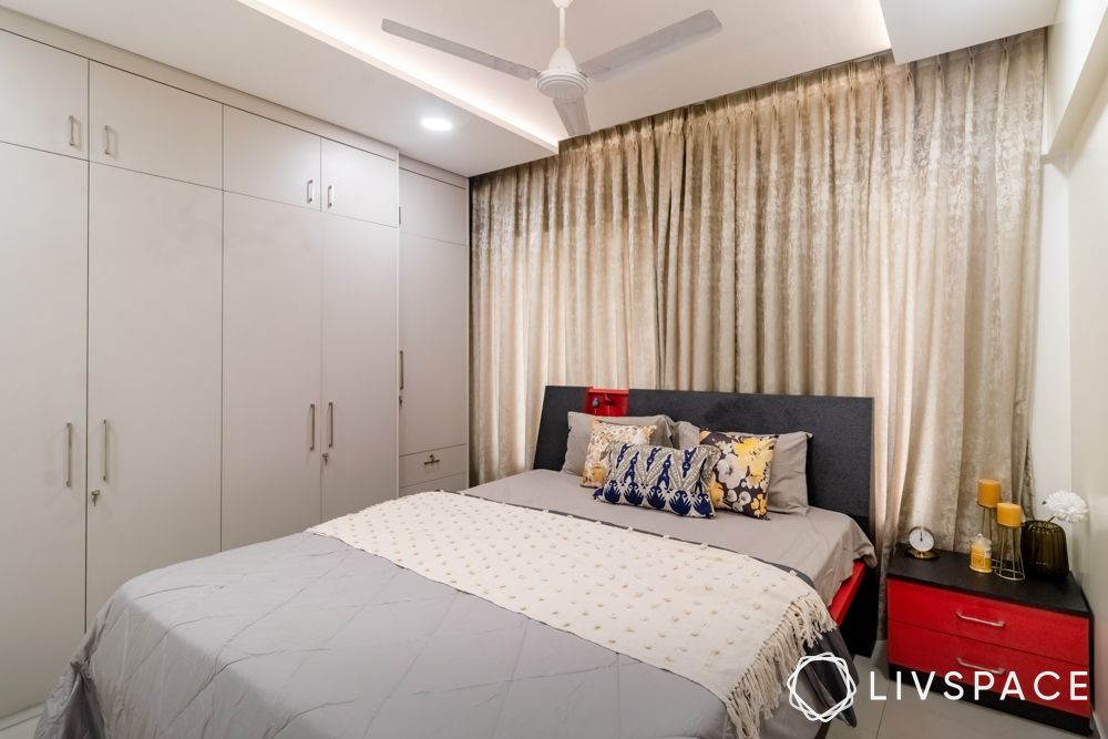 red-bedside-table-with-beige-wardrobes