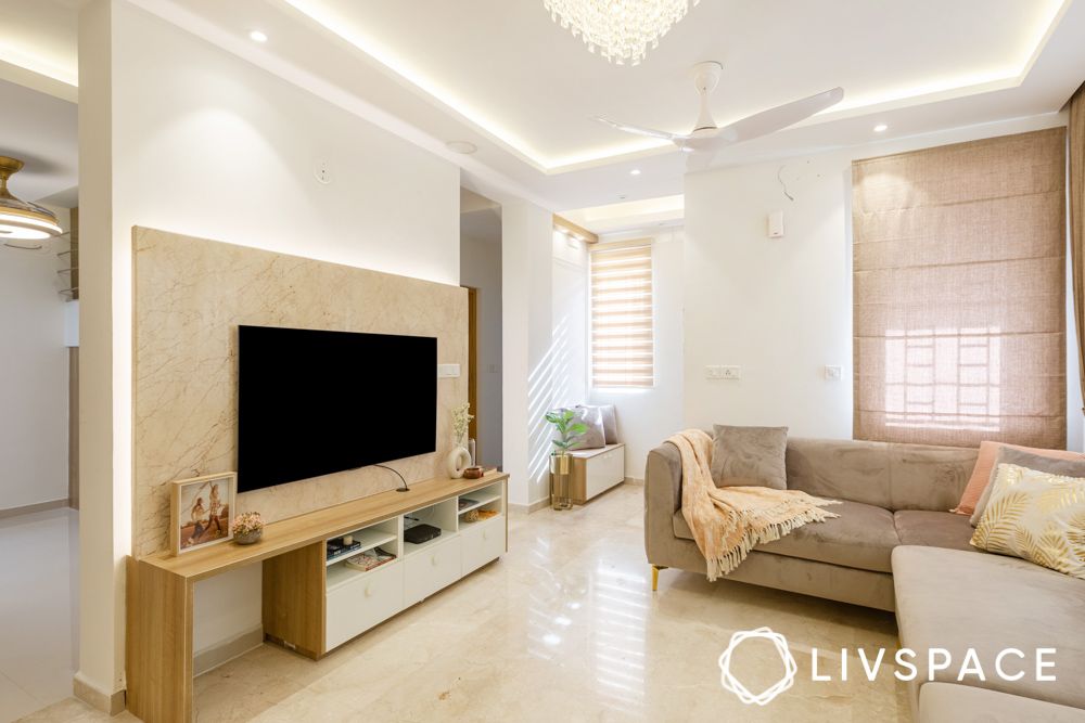 interior-design-for-pacifica-aurum-villas-with-beige-living-room-tv-unit-and-chandelier