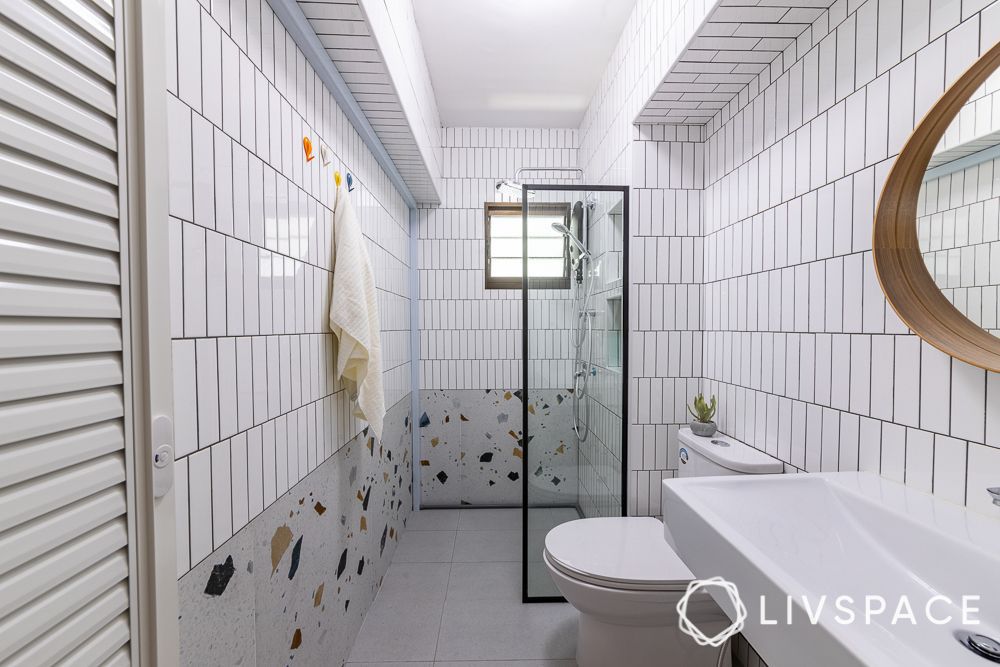 bathroom-vastu-with-tile-flooring-and-patterned-walls