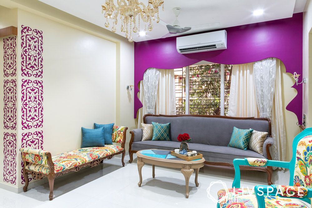 indian-style-hall-colour-combination-in-purple-and-beige-with-curved-furniture-and-motifs