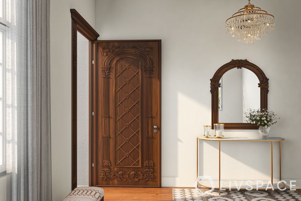 solid-wood-main-door-design-with-carvings-and-foyer-table