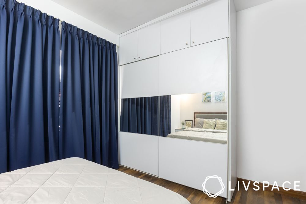 laminate-white-sliding-wardrobe-with-lofts-blue-curtains