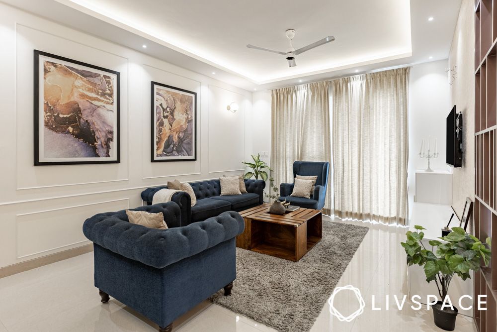 glam-living-room-with-blue-sofas-artwork-wall-trims