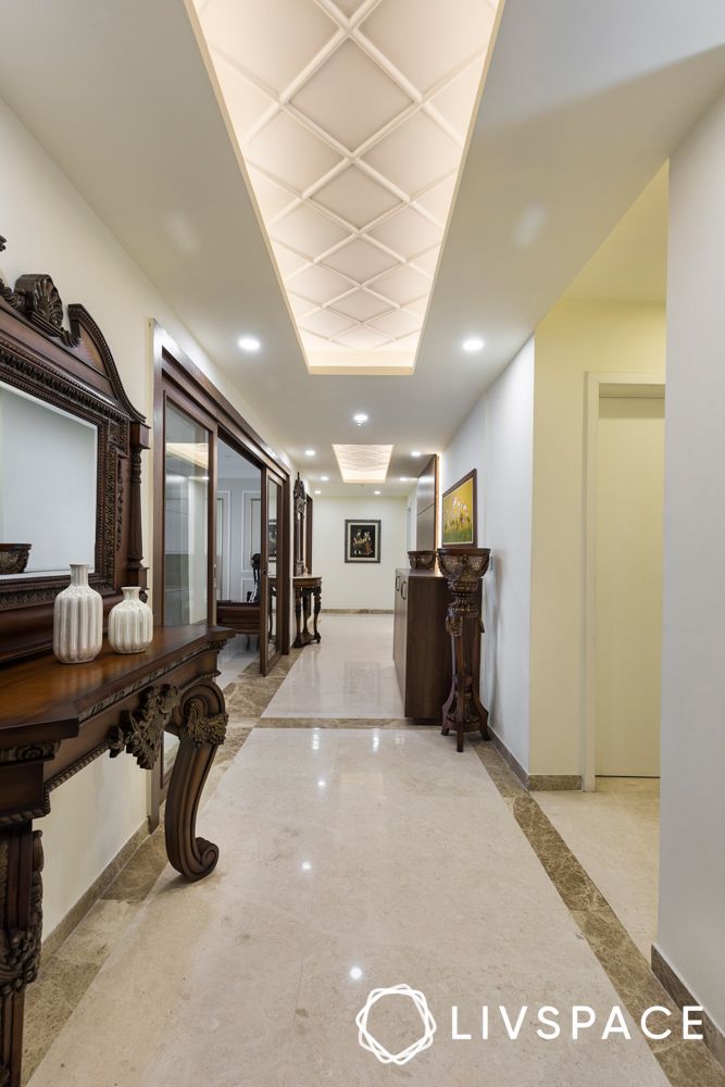 white-granite-flooring-in-hallway-with-lighting-and-dark-wood-furniture