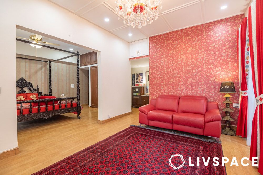 colonial-bed-sabyasachi-wallpaper-red-sofa-chandelier-in-bedroom-lounge