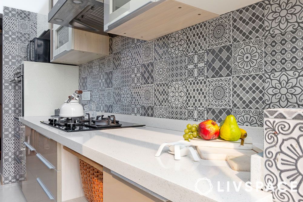 a-white-kitchen-with-a-black-and-white-ceramic-tile-backsplash
