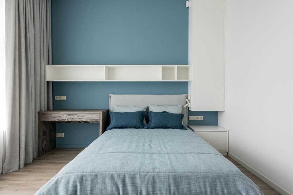 white floating shelves and sky blue bedroom wall