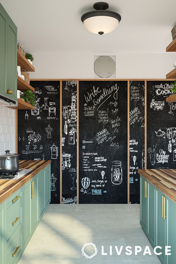 a chalkboard wall with grocery list and messages in a sage green kitchen