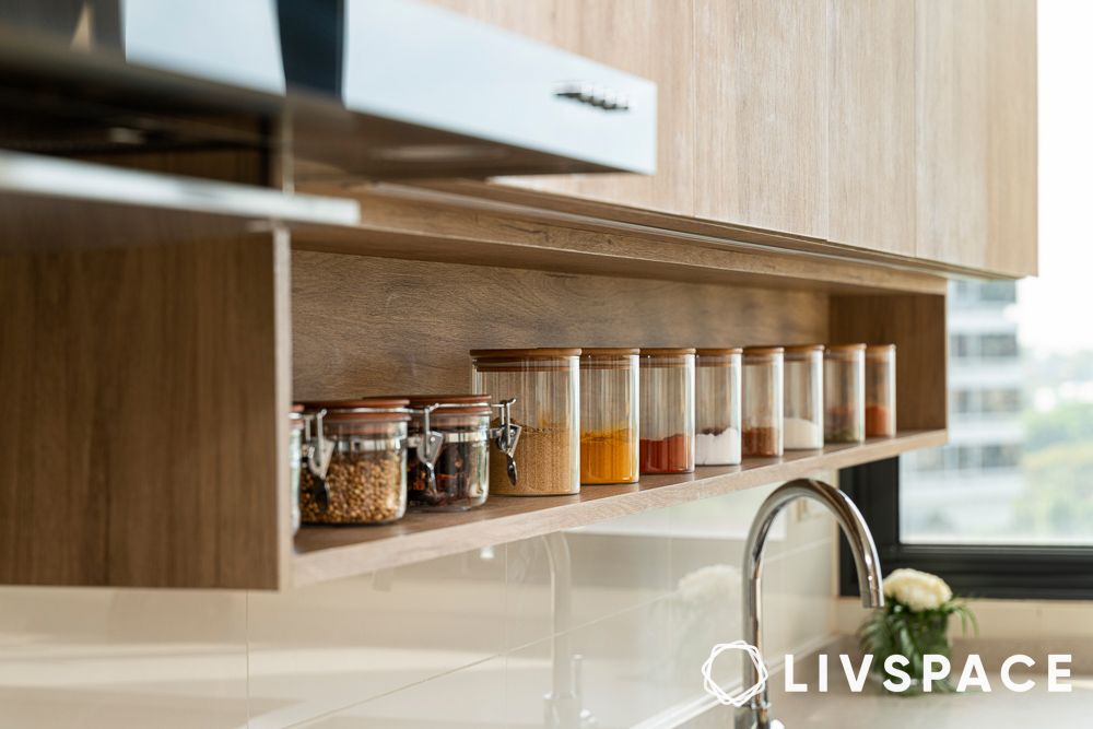 row of identical jars in a wooden kitchen cabinet